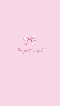 a pink wall with the words i'm just a girl on it and a bow