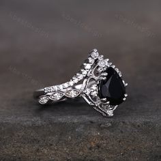 a black and white diamond engagement ring on top of a stone surface with the words,'i do not know what this is