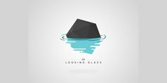 a black rock floating on top of water with the words looking glass written below it