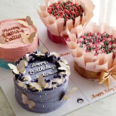 three decorated birthday cakes sitting on top of a table