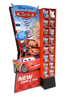 the new cars 2 toys stand is shown in front of an advertisement for disney pixar