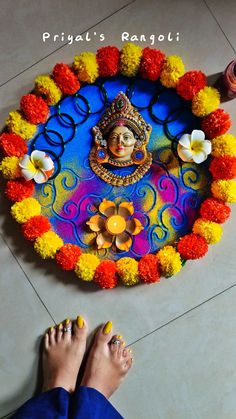 the feet of a person standing in front of a colorful decoration with flowers on it