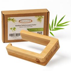 a bamboo toothbrush holder next to a cardboard box with bamboo leaves on the side