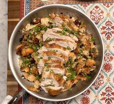 a pan filled with meat and vegetables on top of a table