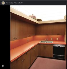 a kitchen with orange counter tops and wooden cabinets