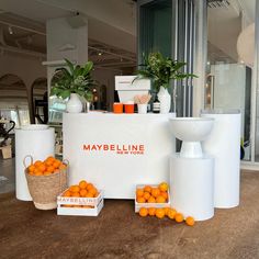 an assortment of oranges are on display in front of a store