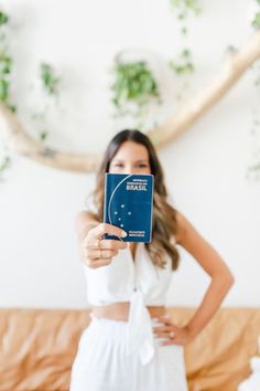 a woman holding up a book in front of her face