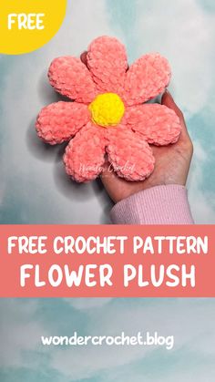 a hand holding a pink flower with the text free crochet pattern flower plush