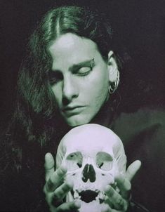 a woman holding a skull in her hands