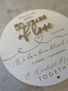 a wedding cake topper with the words 50 years and love written in cursive writing