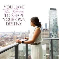 a woman standing on top of a balcony next to a tall building with the words, you have the power to shape your own destiny