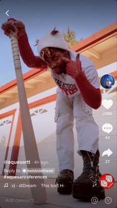 a man in white and red is holding a baseball bat on his left hand while standing next to a pole