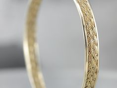 This is such a pretty and classic piece! The texture of the woven center gives the bangle a rich, luxurious profile. It will work great as a stacking bracelet, and is still beautiful all on its own. The condition is fantastic, and the design is light and airy but still substantial with strong, structural lines. Metal: 14K Yellow Gold Width: 6.4 mm Inside Circumference: 7 inches Marks: "14K" Stamped on the clasp Filigree Bangle, Vintage Gold Bracelet, Pearl Bangle Bracelet, Gold Link Necklace, Marquise Shape Diamond, Vintage Rose Gold, Gold Link Bracelet, Pearl Bangle, Tassel Bracelet