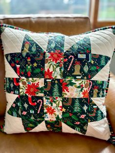 a decorative christmas pillow on a leather chair