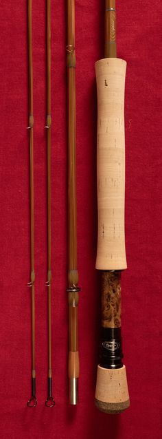 an assortment of fishing rods and lures on a red background