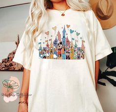 a woman with blonde hair wearing a white disney tshirt