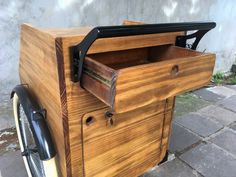 an old fashioned wooden box on the back of a bicycle