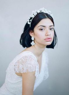 a woman wearing a tiara with flowers in her hair