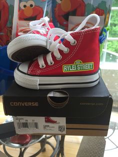 a pair of red and white shoes sitting on top of a box