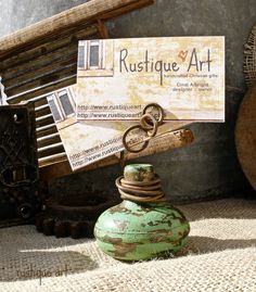 a green vase sitting on top of a floor next to a pile of wooden crates