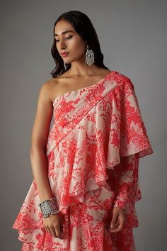 Pink pre-draped ruffle saree with all over blossom print and tiers detailing. Paired with a matching printed one shoulder neck blouse. - Aza Fashions Draped Blouse With Ruffles, One Shoulder Fitted Saree, Elegant Summer Saree With Floral Print, Elegant Floral Print Saree For Summer, Elegant Summer Floral Print Saree, Summer Traditional Drape Georgette Blouse, Summer Fitted Saree With Ruffles, Floral Print Draped Dress For Festive Occasions, Festive Draped Floral Print Dress