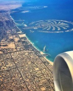 the view from an airplane looking down at some water and land in the middle of the ocean