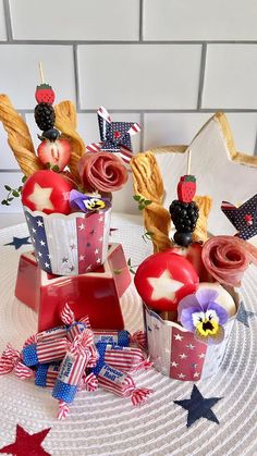 patriotic cupcakes with strawberries and blackberries in them