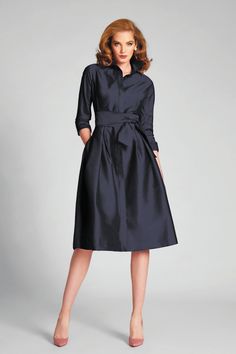 Timeless yet contemporary, this taffeta shirt dress is a must have for your upcoming formal occasions. With elbow sleeves, a tea length cut, and a removable sash belt it is both modest and flattering. The pleated detail throughout the skirt adds flair and movement to this staple piece. Pair with a neutral heel. Collared Neckline Sleeves Front Button Closure Removable Sash A-Line Silhouette Flared Skirt Midi length Wear to bar mitzvahs, semi-formal events, and holiday gatherings Shop cocktail dre Best Cocktail Dresses, Elegant Shirt Dress, Mother Of The Bride Fashion, Short Black Cocktail Dress, Cocktail Dresses With Sleeves, Navy Cocktail Dress, Black Peplum Dress, Tea Length Skirt, Three Quarter Sleeve Dresses