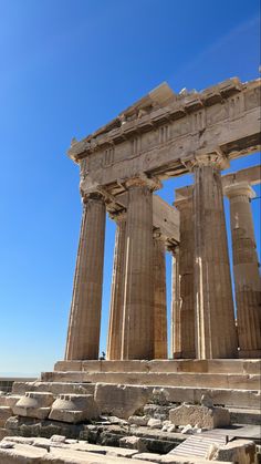 the ruins of an ancient greek temple against a blue sky