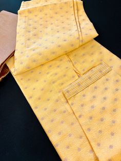 The sunny yellow hue of this men's kurta symbolizes the auspicious beginning of a new chapter, making it an ideal choice for your Haldi ceremony, pooja ceremonies and other occasions. The Kurta has made from self embroidered design material with Antiques zari. Item : Men's Kurta PajamaReady to Wear : YesKurta Color : Yellow , Haldi Color familyPajama Color : White Fabric : Jute Silk Lining (Yes/No) : No (You can wear a soft cotton T-shirt in case of sensitive skin)Disclaimer -For sizing please r Yellow Sherwani For Puja And Eid, Yellow Sherwani For Eid Puja, Traditional Yellow Kurta For Ceremonial Use, Yellow Bandhani Print Unstitched Kurta, Yellow Cotton Straight Kurta Sherwani, Yellow Bandhani Print Traditional Wear For Puja, Yellow Bandhani Print Kurta For Diwali, Yellow Cotton Sherwani Straight Kurta, Yellow Bandhani Traditional Wear For Puja