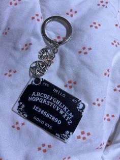 a black and white keychain with a name tag attached to it's side