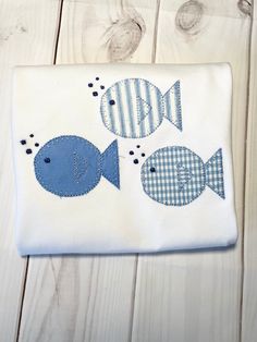 a blue and white fish appliqued with gingham fabric