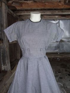 This is a vintage black and white cotton blend full skirt dress from the 1950's.  It features short kimono sleeves, a fitted midriff with 2 rows of loops, and a full circle skirt.  The skirt is completely lined in black buckram to keep it's shape.  This dress opens down the back with a well working metal zipper.  There is a little discoloration at the underarms, but I have not had this dress cleaned.  The label is from "Coplin's", which was a very nice women's shop in Milwaukee.   Comes from a s Lined Cotton Vintage Short Sleeve Dress, 1950s Short Sleeve Lined Vintage Dress, 1950s Short Sleeve Cotton Dress, 1950s Style Short Sleeve Cotton Dress, 1950s Style Short Sleeve Cotton Vintage Dress, 1950s Style Cotton Dresses With Short Sleeves, Vintage Short Sleeve Dresses With Fitted Waist, Cotton Vintage Dress With Short Sleeves, 1950s Style Cotton Vintage Dress With Short Sleeves