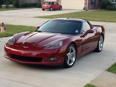 a red sports car parked in front of a house