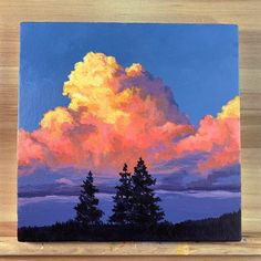 a painting of clouds and trees on a wooden surface