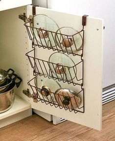 pots and pans are stored in a rack next to the kitchen counter top,