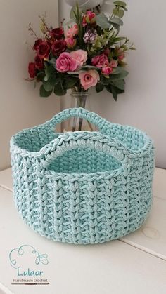 a crocheted basket sitting on top of a table