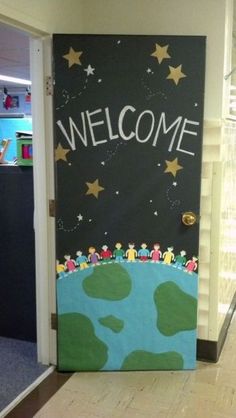 a door decorated with an earth and stars welcome sign