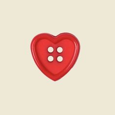 a red heart shaped button with three white buttons on it's side, in the shape of a heart