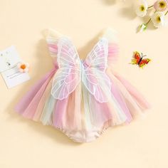 Dress your little angel in whimsy and color with our Baby Butterfly Wing Romper Dress. Designed for infant girls, this romper dress combines the comfort of a romper with the charm of a summer dress. Featuring exquisite embroidery of butterfly wings, fly sleeves, and a rainbow-colored tulle skirt, this outfit is a dream come true for summer days. The highlight of this romper dress is the beautifully embroidered butterfly wings on the back, adding a magical touch to your baby girl's outfit. Delica Girls Party Wear, Capes For Kids, Beautiful Fairy, Dress Embroidery, Colour Ways, Birthday Special, Infant Girl, Floral Print Rompers, Embroidered Butterfly