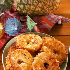 some fried food on a plate next to a pineapple