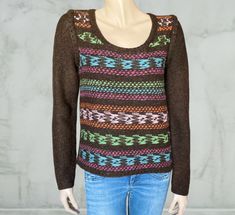 a mannequin wearing a sweater with multicolored knits on the shoulders