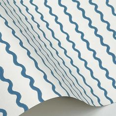 an image of a white and blue wallpaper with wavy lines on it's surface