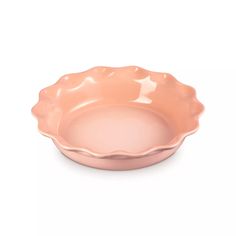 a pink bowl sitting on top of a white table