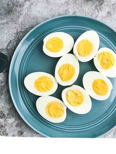 four hard boiled eggs on a blue plate