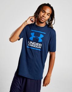 a man with dreadlocks and under armour t - shirt posing for the camera