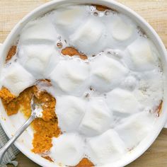 a bowl filled with marshmallows and orange sauce