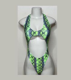 Welcome to my shop Let's Make Money Together 💕 DETAILS  * Handmade Item  * Materials: Nylon, Spandex * Front Cut-Out Bodysuit  * Never used  DESCRIPTION  * Thong Bodysuit  * Neon Green Snake Print Spandex * 4 way stretch Fabric  * Mannequin is wearing XS/Small (may choose sizing at checkout)  SHIPPING  My current shipping turnaround is really quick 1 to 2 days  RETURNS & EXCHANGES  No refunds or exchanges if you have any issues with your purchase please feel free to reach me personally. I can a Summer Festival Dancewear Bodysuit, Green Rave Bodysuit For Party, Green Stretch Rave Bodysuit, Green One-piece Bodysuit For Club, Green One-piece Club Bodysuit, Fitted Green Bodysuit For Festival, Fabric Mannequin, Club Attire, Green Snake