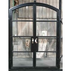 an arched glass door in front of a building