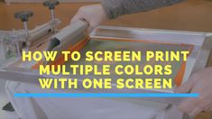 a person using a screen printing machine to print multiple colors with one screen on the printer